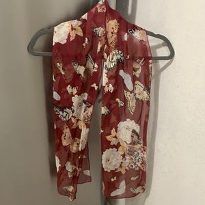 Red scarf with butterfly and flower designs.